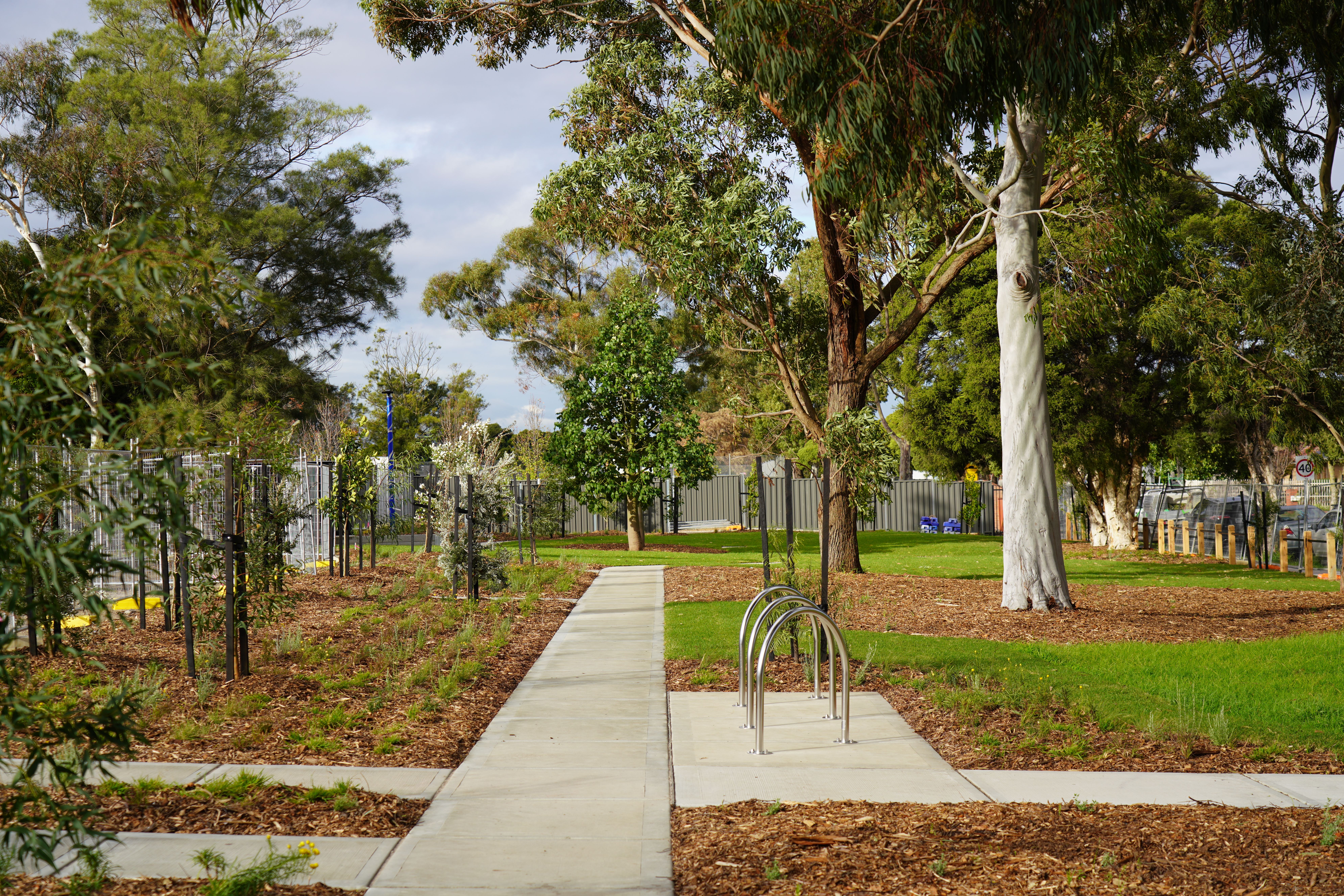 Coomoora Springvale South open space with trees, grass and bike racks