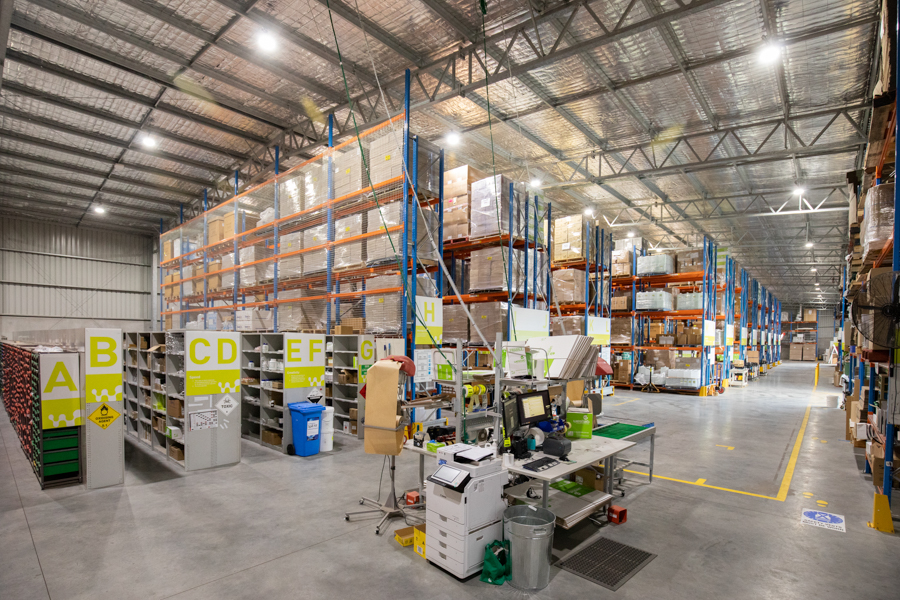 Inside a warehouse facility, machinery and shelving units.