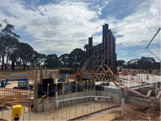 COnstruction of bull pens at Werribee Zooo - machinery and slabs of concrete flooring and walls.